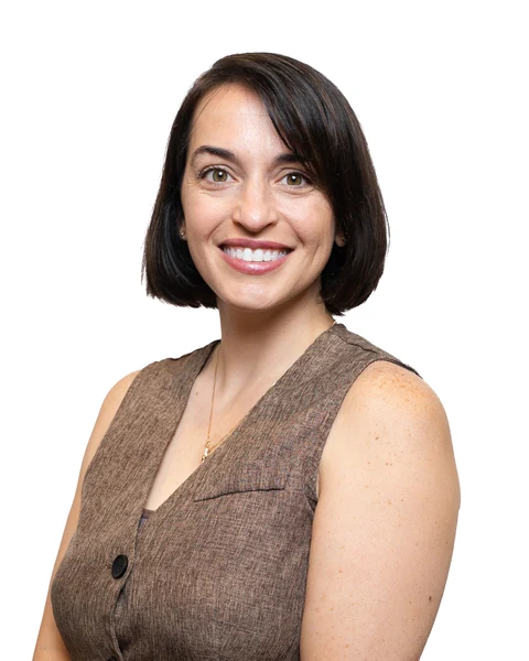 Professional headshot at the Clark Insurance office opening, Magnolia, TX: woman with a short dark bob in a brown vest
