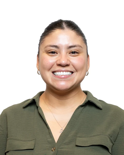 Professional headshot at the Clark Insurance office opening, Magnolia, TX: woman in an olive button-up shirt