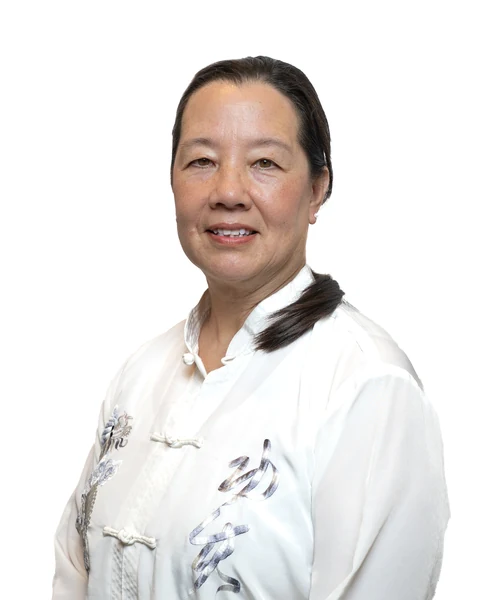 Professional headshot at the Clark Insurance office opening, Magnolia, TX: woman in a white embroidered jacket