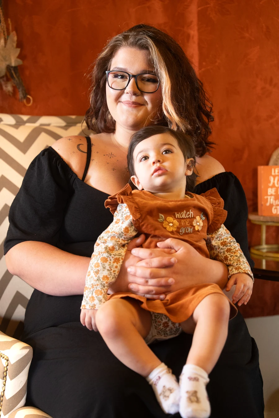 Mother holding her baby on a fall family portrait set