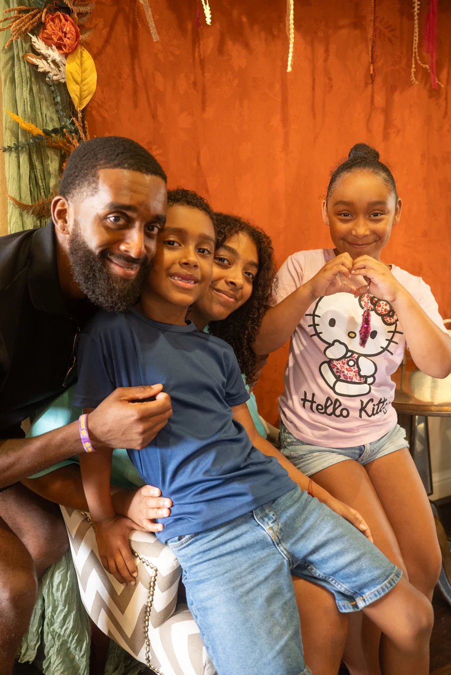 Father with three children on a fall family portrait set