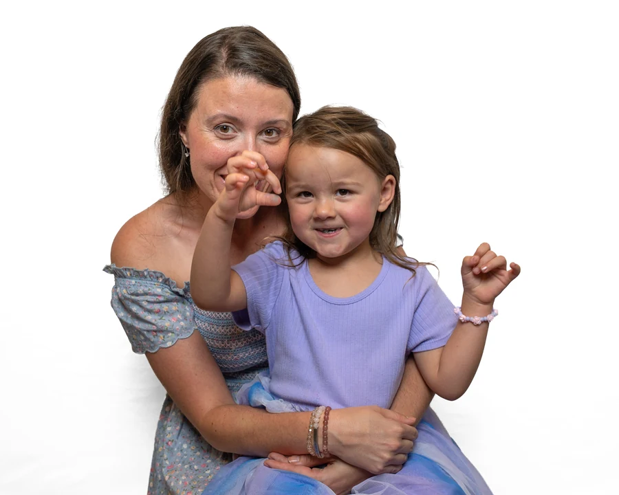 Mother and daughter on a white backdrop
