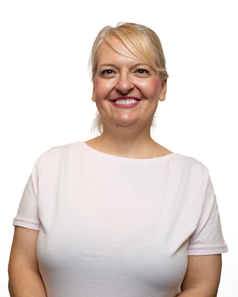 Professional headshot at the Clark Insurance office opening, Magnolia, TX: woman with blonde hair in a light pink T-shirt