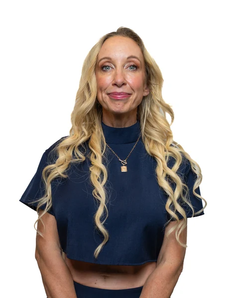 Professional headshot at the Clark Insurance office opening, Magnolia, TX: woman with long wavy blonde hair in a navy top