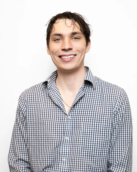 Professional headshot at the Clark Insurance office opening, Magnolia, TX: man in a checkered button-up shirt