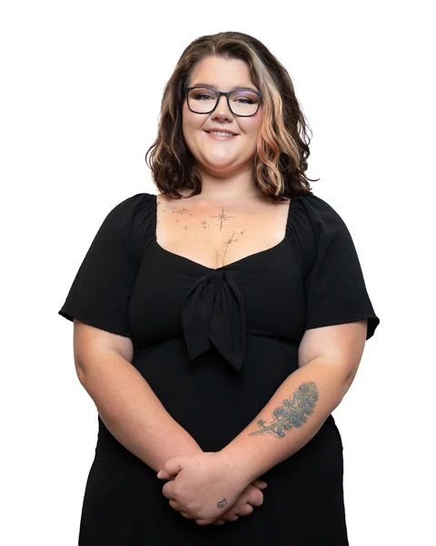 Professional headshot at the Clark Insurance office opening, Magnolia, TX: woman with glasses in a black dress