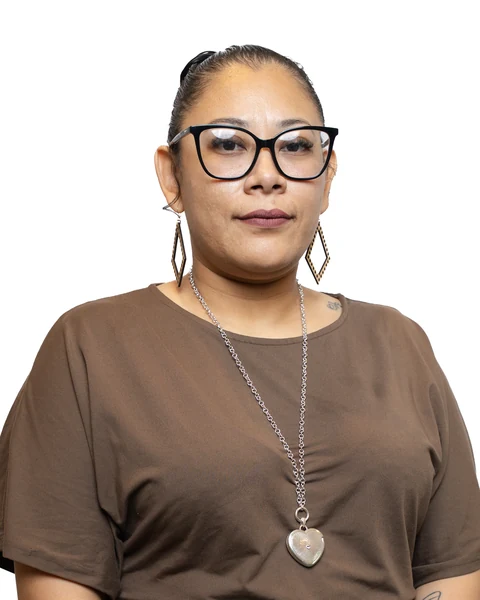 Professional headshot at the Clark Insurance office opening, Magnolia, TX: woman with glasses in a brown top and heart pendant